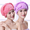 Two women wearing fluffy microfiber hair drying towel caps in pink and purple colors
