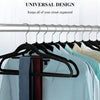 A set of black velvet slim hangers hanging on a metal rod, used for organizing a closet.