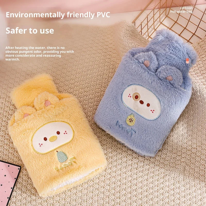 A light blue plush animal hot water bottle next to a yellow plush animal hot water bottle on a beige fabric.