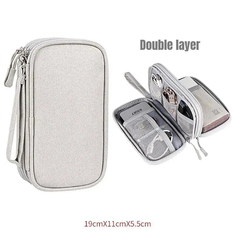 A double layer portable storage organizer pouch in silver gray fabric with a zippered compartment.