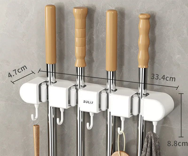 Wall mounted broom holder with wooden handles and chrome rods for kitchen or bathroom