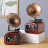 A vintage-style retro phonograph music box decor with a rose gold tone and a large, bronze-colored diaphragm.