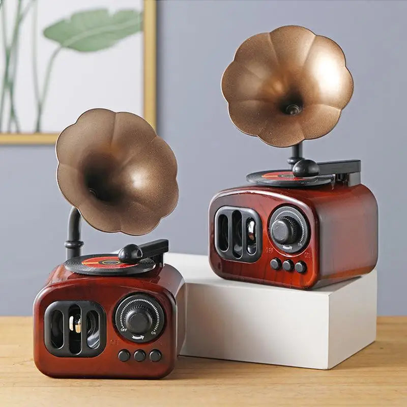 A vintage-style retro phonograph music box decor with a rose gold tone and a large, bronze-colored diaphragm.