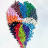 A vibrant collection of round building blocks in various colors forming a textured, organic shape.