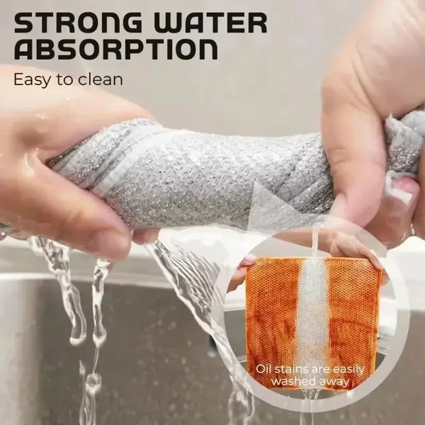 A hand is using a thickened steel wire cleaning cloth to wash away oil stains in a sink.