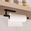 Porta toallas autoadhesivo de acero inoxidable negro montado bajo una estantería de madera, sosteniendo un rollo de toalla bl