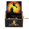 A wooden music box featuring a Halloween-themed scene with a bat-winged witch silhouette against an orange moon.