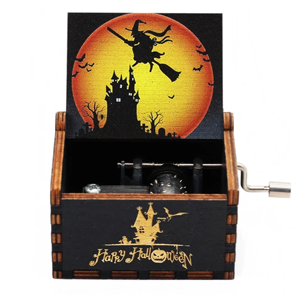 A wooden music box featuring a Halloween-themed scene with a bat-winged witch silhouette against an orange moon.
