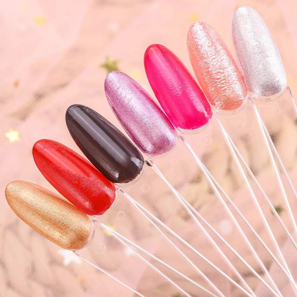 A set of colorful nail art practice false tips in various shades including pink, red, purple, and gold.