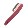 Brosse multifonction rose pour nettoyer chaussures et vêtements avec poils.