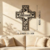 A black metal cross wall art decoration with a dove design mounted on a beige wall.
