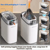 A white automatic sensor trash can with a clear lid and an inner bag is shown, demonstrating one-click packaging.