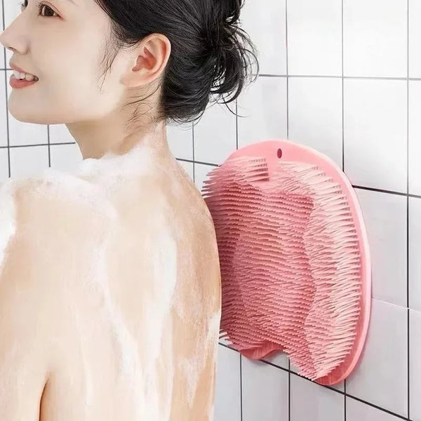 A pink suction cup foot massage mat is shown against a white tiled background.