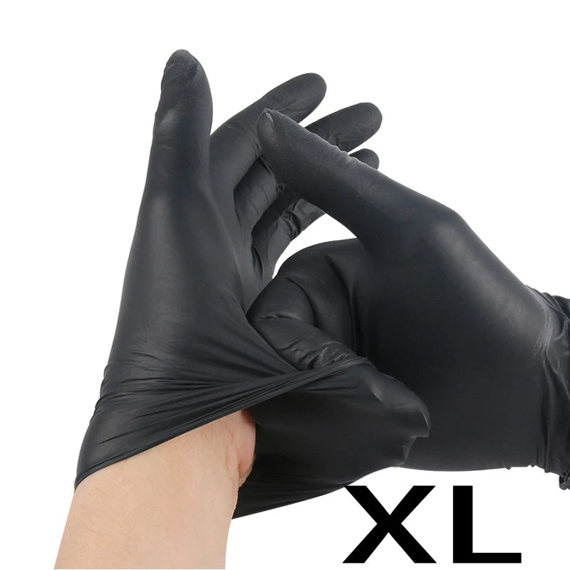 A hand wearing a black disposable nitrile glove is shown holding another glove, with the letter XL visible.