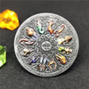 A silver commemorative coin featuring twelve zodiac constellations, including the Sagittarius and Scorpio, set against a dark