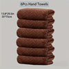 A stack of six brown quilted hand towels, measuring 13.8 x 29.5 inches each.