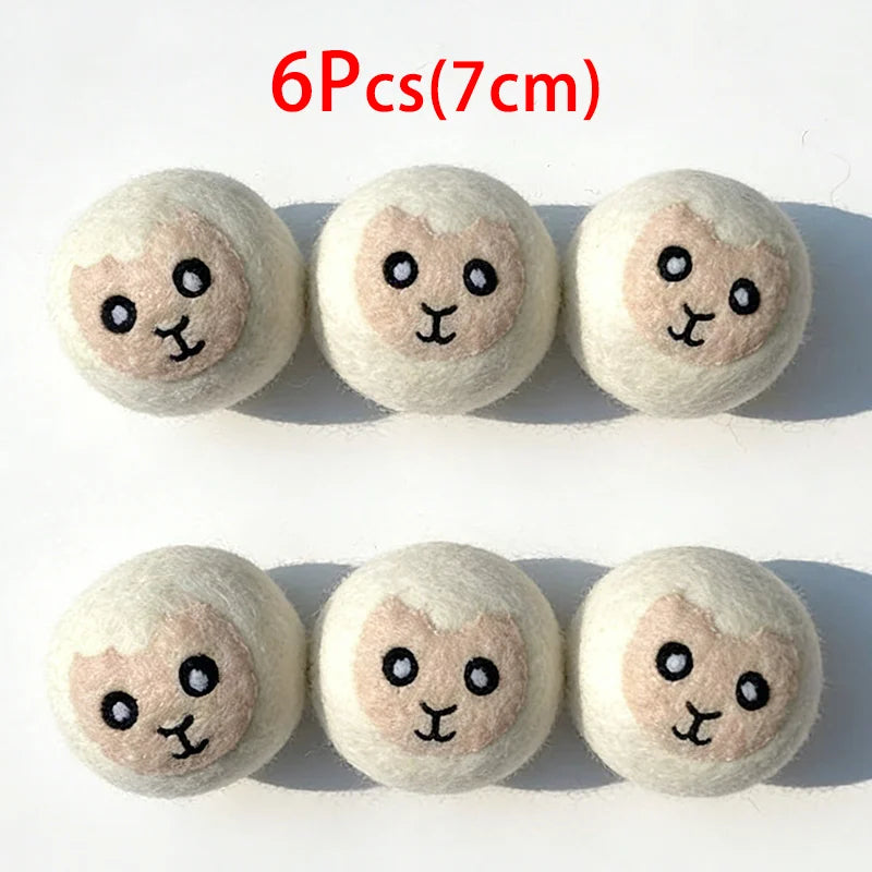 Six round, light beige wool dryer balls with small black facial features.