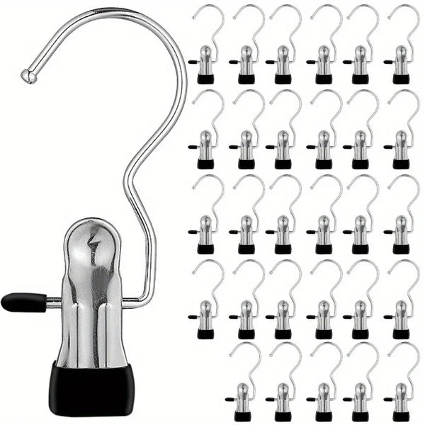 A set of premium stainless steel clothes pegs and hooks with black bases.