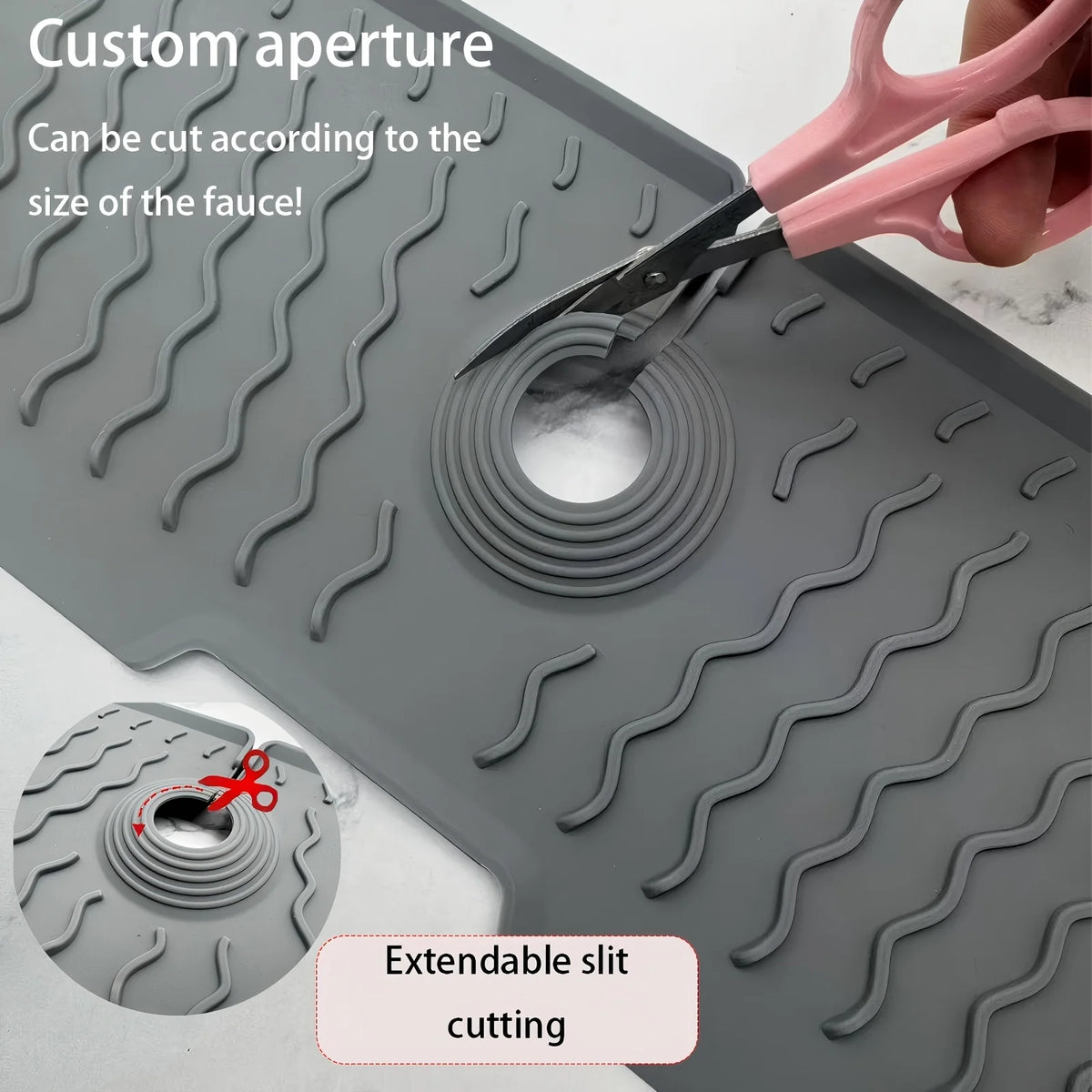 A silicone kitchen sink splash guard mat with a custom aperture being cut by scissors.