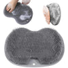 A gray wall mounted shower foot scrubber is shown with a hand and a sponge, and the full scrubber product.