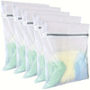 A pack of four white fine mesh laundry bags with silver zippers, showing a light green and yellow-tinted fabric.