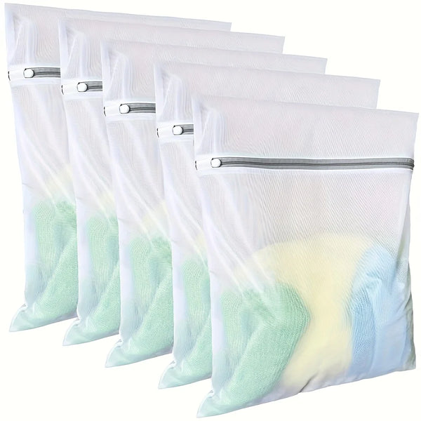 A pack of four white fine mesh laundry bags with silver zippers, showing a light green and yellow-tinted fabric.