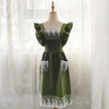 A green linen kitchen apron with white lace detailing displayed on a mannequin.