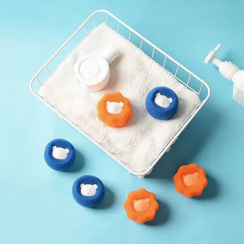 A white mesh laundry bag holds several blue and orange reusable pet hair catcher balls on a light blue background.