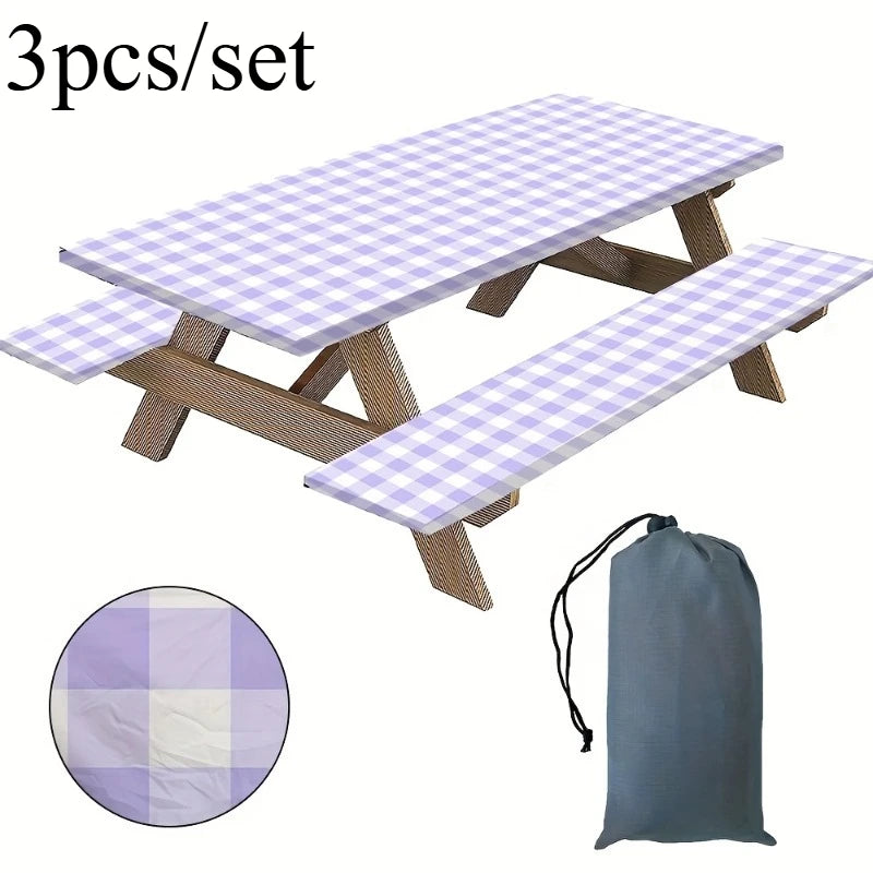 A set of three plaid tablecloths or mats with wooden frames and a gray storage bag.
