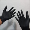 A pair of black heavy duty disposable nitrile gloves held up against a white background.