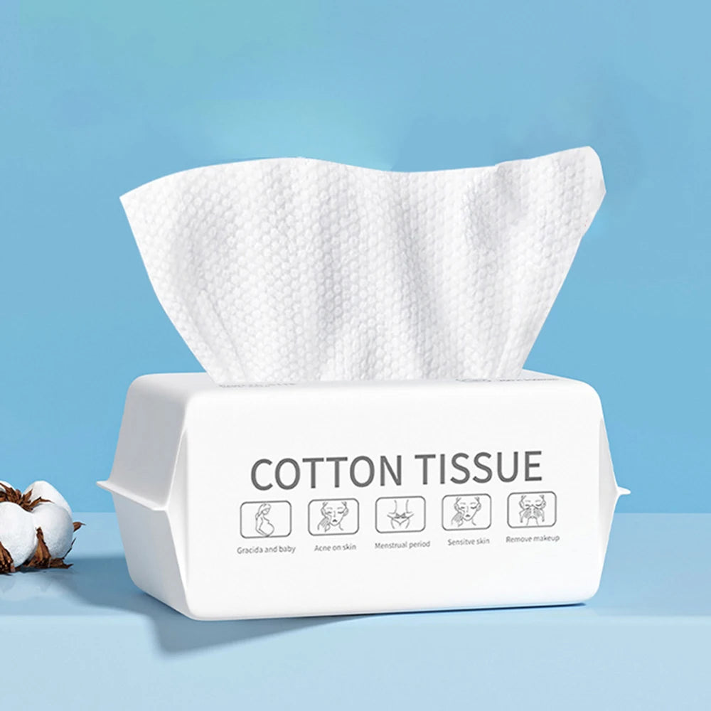 A white box of disposable cotton tissue with icons showing uses for skin, menstrual period, and makeup removal.