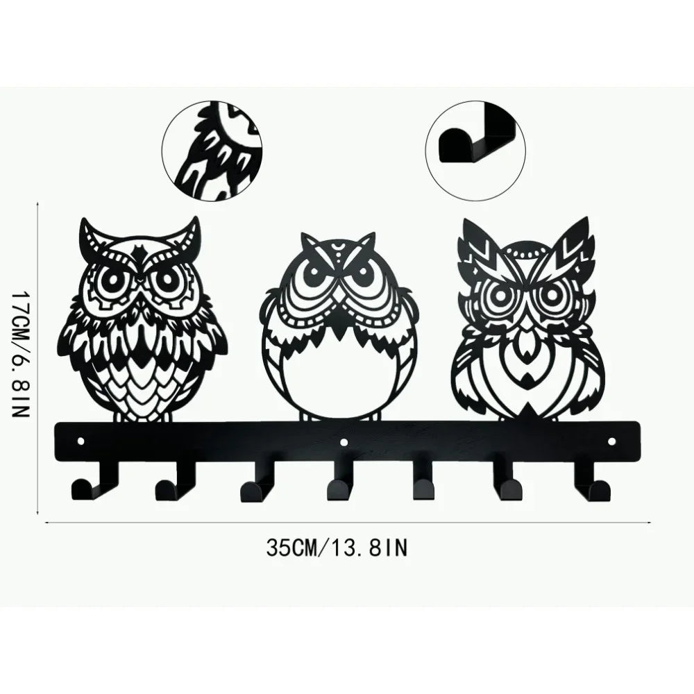 Black decorative metal key holder rack with multiple hooks for keys and accessories.