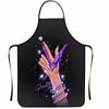 A black apron featuring a purple nail artist design with sparkling glitter and manicured nails.