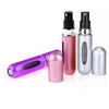 A set of five portable refillable perfume spray bottles in various metallic and pink colors.