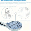 A stainless steel clog pick needle and a silicone cleaning brush are shown on a shower head.