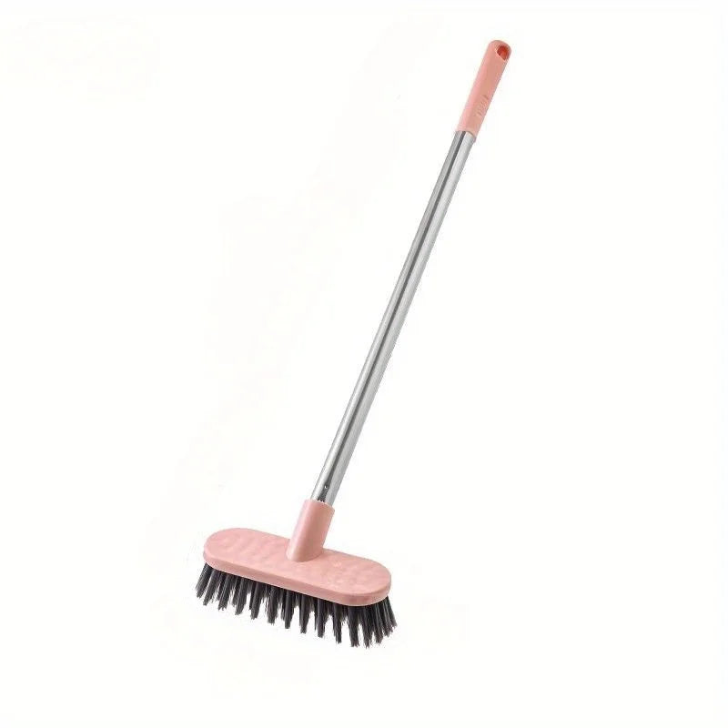 A long-handle floor scrub brush with a pink handle and a pink cleaning pad.