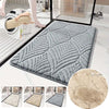 A collection of plush non-slip bathroom rugs in various shades of gray and beige, shown with a close-up view.