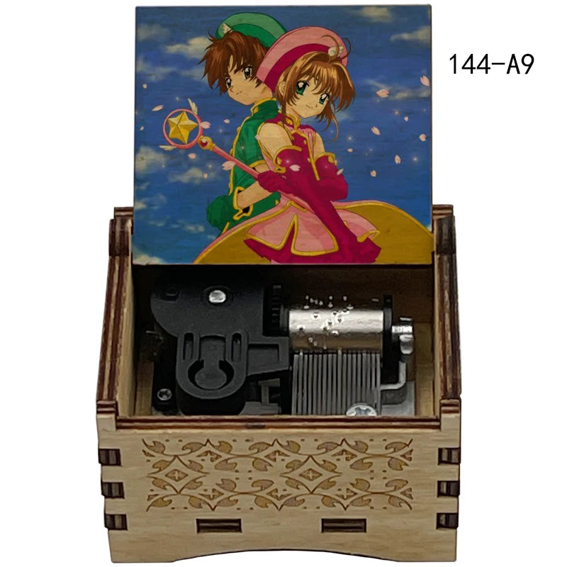A wooden box containing a painted figure of two characters and musical tone boxes labeled 144-A9
