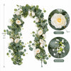 An artificial eucalyptus and rose garland featuring white flowers and green foliage.