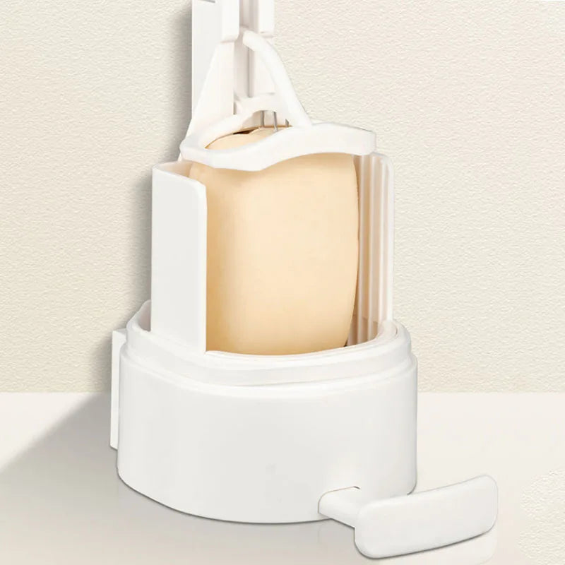 A white portable soap bar grinder with a wall-mount design is shown on a light surface.