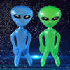 Two inflatable alien decorations, one blue and one green, standing against a dark background.