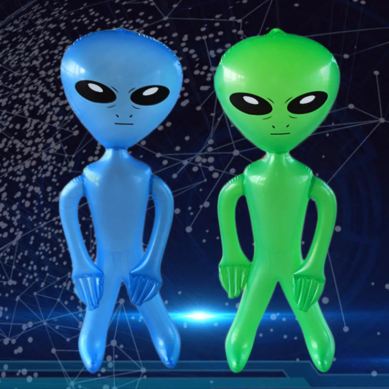 Two inflatable alien decorations, one blue and one green, standing against a dark background.