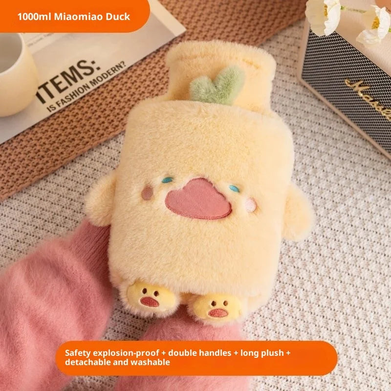 A fluffy yellow plush duck toy with pink accents is shown being held by a hand.