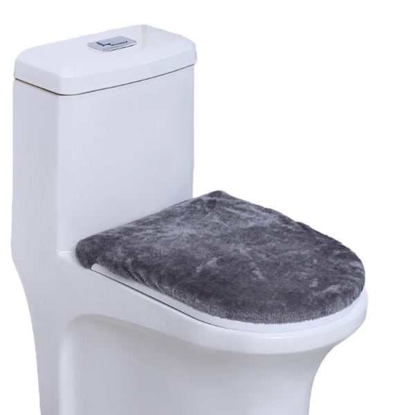A white toilet with a gray protective seat cover installed.