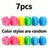 Sieben bunte, farbenwechselnde Reinigungsschwämme mit Smiley-Gesichtern in Pink, Gelb, Grün und Blau.