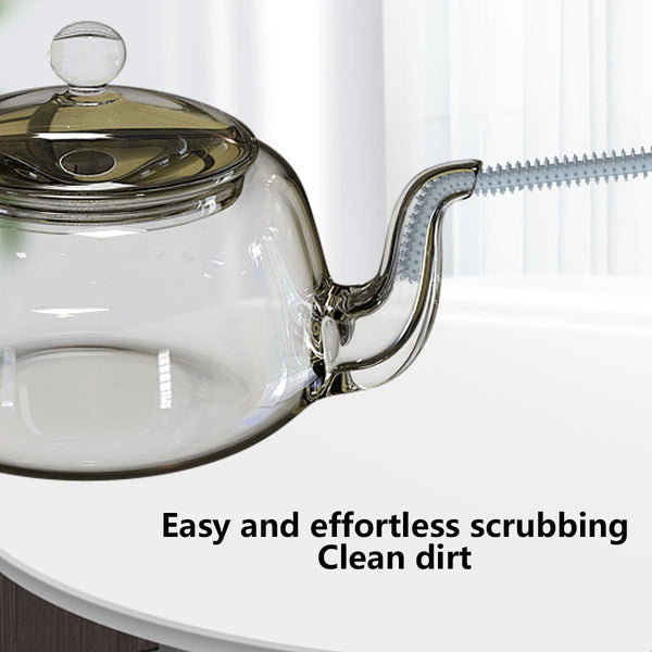 A clear glass teapot with a silicone straw cleaning brush attached, demonstrating easy and effortless scrubbing.