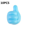 Ganchos de pulgar azules de silicona para pared, usados para organizar cables y accesorios.