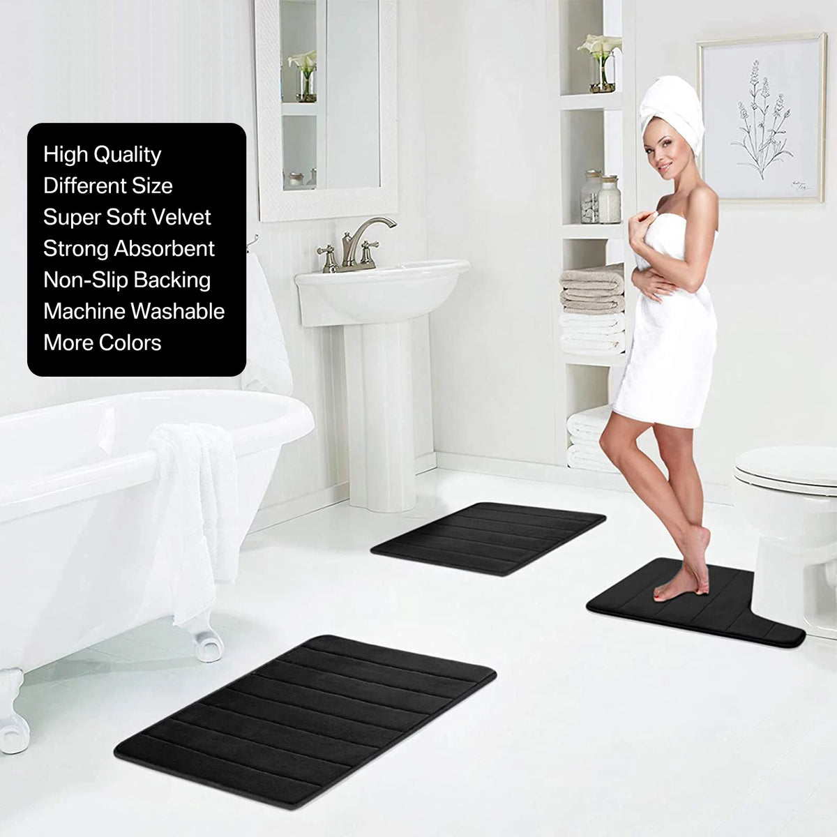 A set of black non-slip bath mats and a white bathrobe displayed in a bathroom setting.