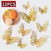 Twelve gold-colored decorative butterfly wall stickers displayed on a white background.