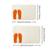 A pair of orange plush non-slip bathroom rugs displayed on a white background.